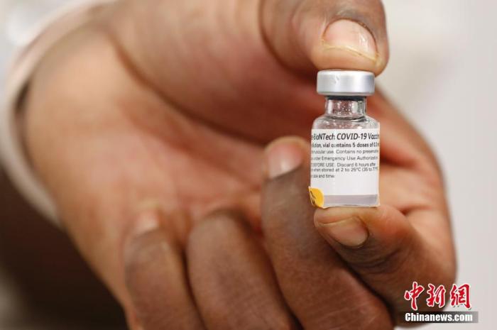 当地时间12月14日，纽约长岛犹太医疗中心护士展示美国首批新冠疫苗。当日，辉瑞公司首批近300万剂新冠疫苗陆续运抵美国各地。 /p中新社记者 廖攀 摄